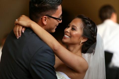 A bride and groom dancing together