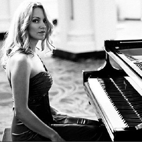 Diana sitting in front of a piano 