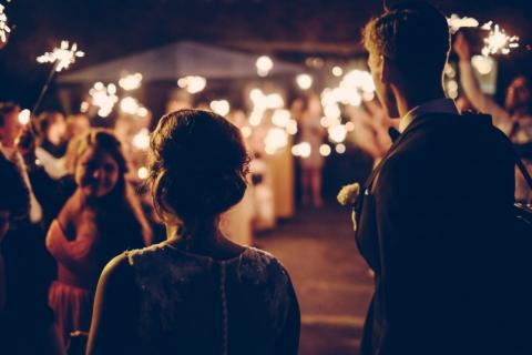 A wedding with guest holding sparklers