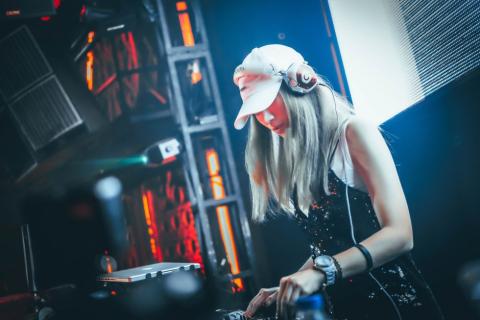 A woman DJing on stage