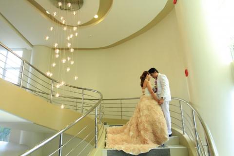 A bride and groom on a flight of stairs