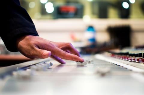A hand on a dj board