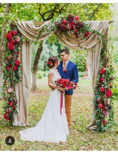 A bride and groom under a arch