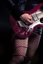 A woman playing guitar 