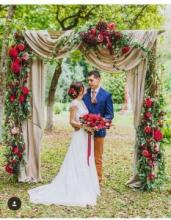 A bride and groom under a arch